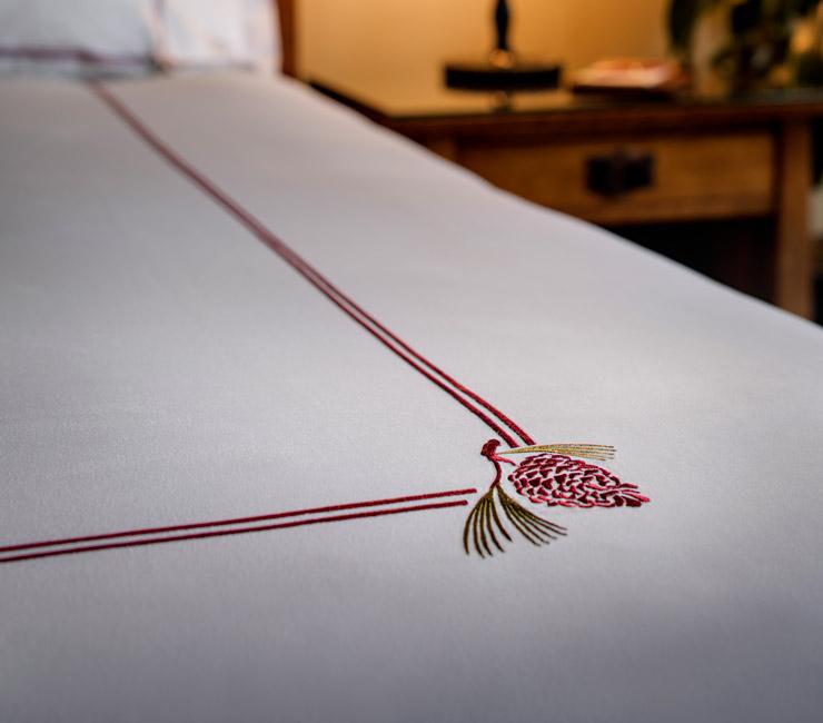 Egyptian cotton linens with signature pine cone made exclusively for The Lodge at Torrey Pines