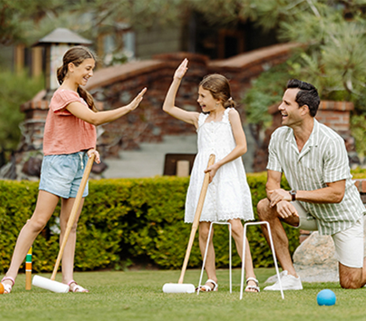 Family enjoying a round of croquet on the Arroyo Terrace